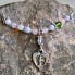 Tiny Footprints Gemstone Miscarriage Necklace Displayed on a Stone